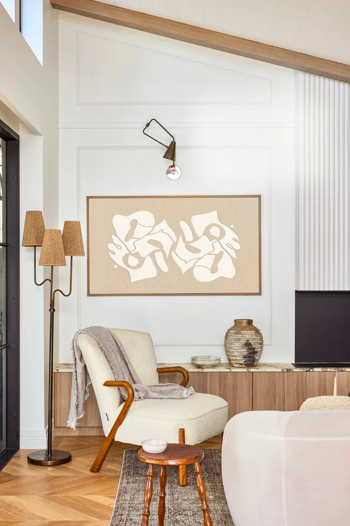 Californian bungalow renovation living room with neutral boucle armchair and frame tv and wainscoting