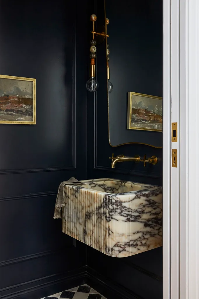 Californian bungalow renovation powder room with a marble basin and brass tapware and wainscoting painted in dulux oolong