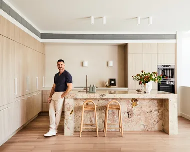 Darren Palmer's kitchen with Darren standing next to the bench