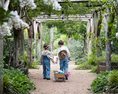 Easter Egg Hunt Children Pulling Cart Under Archway