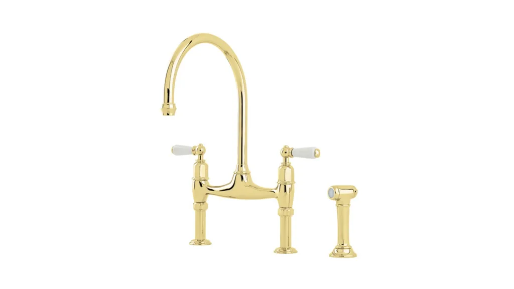 A traditional style kitchen mixer tap from Perrin & Rowe, available through The English Tapware Company, in a gold finish with white porcelain levers.